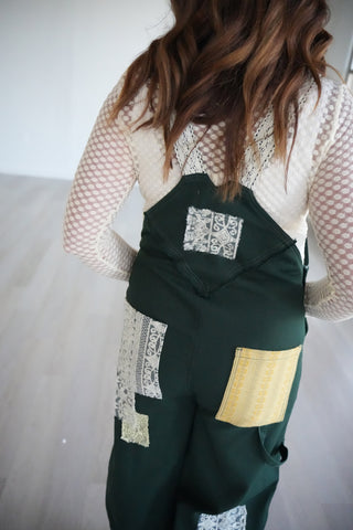 Legacy Overalls back view with lace patches and a gold back pocket