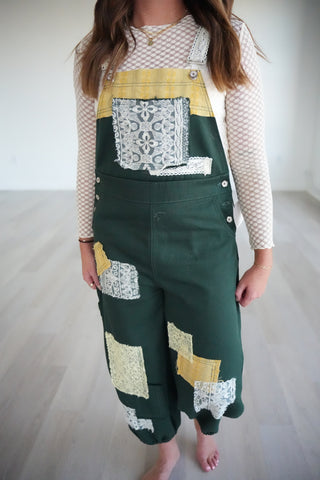 Legacy Overalls front view with a cream lace top